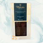 Moksha Chocolate 70% Single Origin Cacao Dark Chocolate from Maya Mountain, Belize, in white and navy blue packaging with a clear window showing the dark chocolate bar.